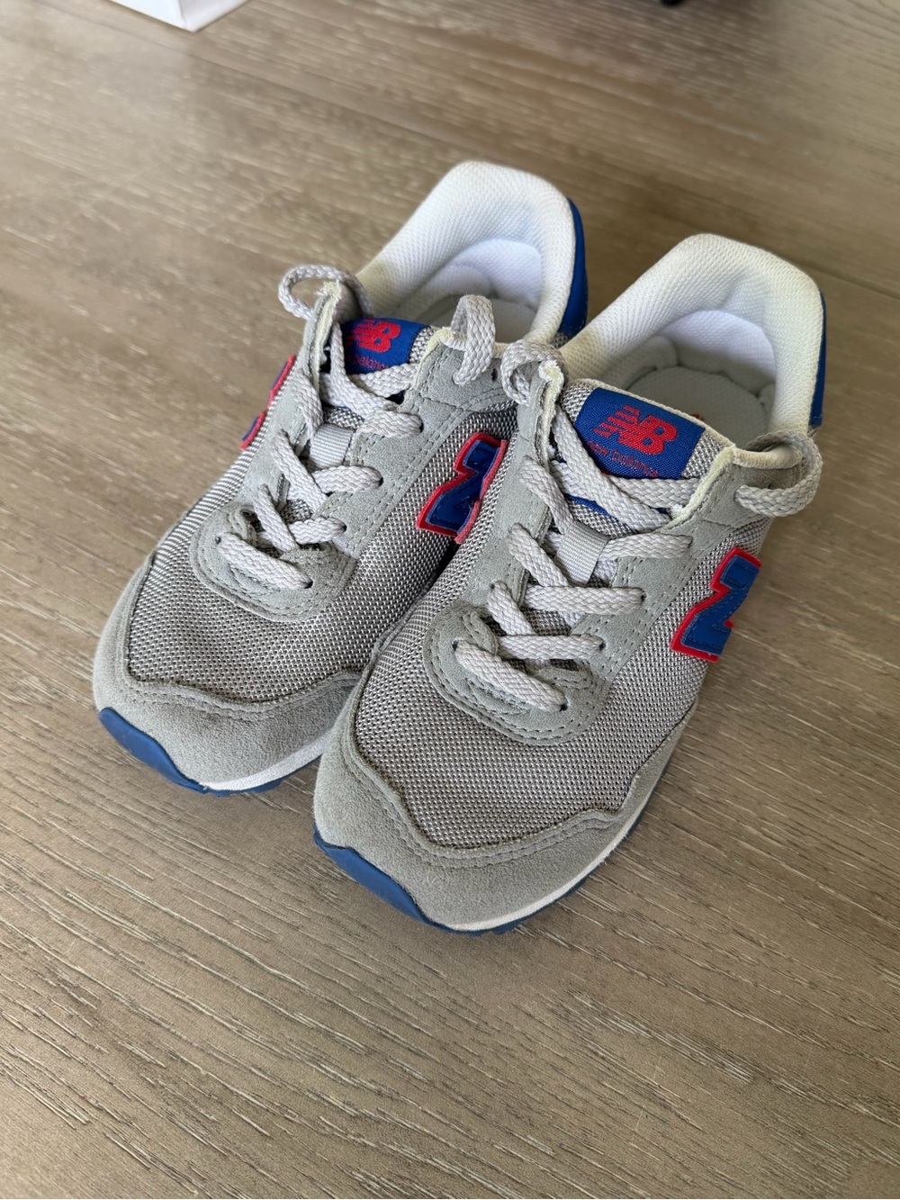 New Balance Kids Gray Sneakers with Blue and Red Accents